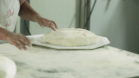 Baker-Put-The-Kneaded-Dough-On-The-Divider-Rounder-Plate-And-Sprinkle-With-Wheat-Flour