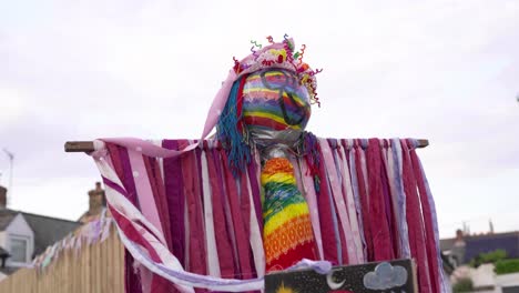 Colorful-Costume-And-Rainbow-Painted-Face-Scarecrow-Displaying-Outdoor-In-Time-Of-Covid-19-Pandemic---Low-Angle-Shot