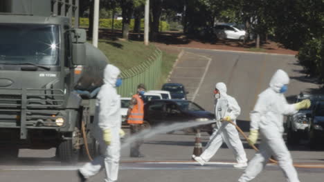 Brazilian-Military-personnel-begins-hosing-down-the-road-outside-of-a-contaminated-hospital