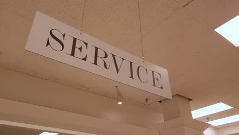 Service-sign-hanging-from-store-ceiling