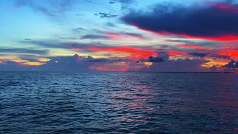 Red-and-crimson-colors-of-the-sky-over-the-ocean-and-clouds-in-Florida-Keys,-USA