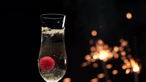 Champagne-flute-and-strawberry-splashing-with-sparklers-fireworks