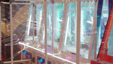 Close-up-shot-of-transparent-plastic-foil-separating-arcade-games-inside-gaming-hall