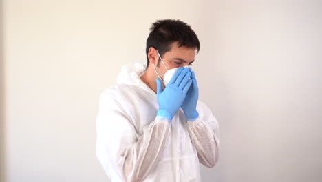 Doctor-in-PPE-suit-putting-on-a-face-mask-in-profile-to-the-camera