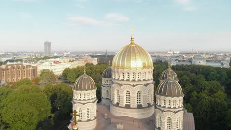 Amazing-aerial-view-of-Nativity-of-Christ-cathedral-in-Esplanade-park,-Riga,-Latvia,-tilt-up,-sunny-day
