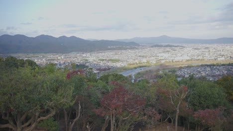 Kyoto-city-and-River-seen-from-Arashiyama-Mountain,-Pan-Shot