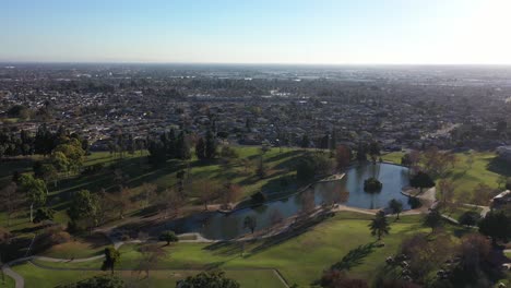 Drone-shot-flying-away-from-the-lake-at-the-La-Mirada-Regional-Park