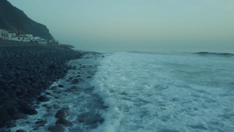 Waves-Crashing-On-Rocky-Coast-In-Paul-do-Mar,-Madeira-Island,-Portugal---aerial-drone