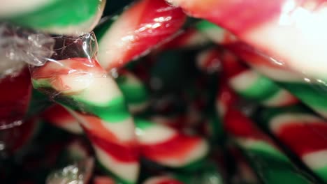 Great-macro-view-of-several-wrapped-red,-white,-green-mini-candy-canes