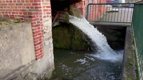 Flowing-water-falling-down-from-the-mountain-waterway-landing-into-sewer-tunnel