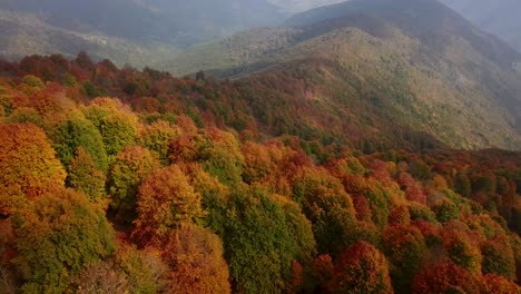 Drone-Shot-Aerial-Colorful-Forest-in-Fall-Winter-Move-on-Beautiful-Mountain-Ridge-with-Sunset-Golden-Ray-and-Clouds-Shadow-in-Wonderful-Landscape-Hiking-to-Savadkuh-Rural-Wild-Nature-Couple-Camping