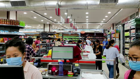 People-wearing-face-masks-purchase-goods-at-a-supermarket-during-Coronavirus-Pandemic-Lockdown