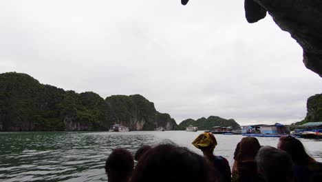 Cruising-along-Ha-Long-Bay-amongst-towering-limestone-islands-in-the-sea-with-cloudy-skies