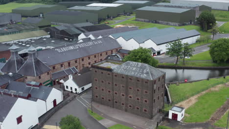 Bushmills-Distillery-Northern-Ireland,-Pull-out-aerial-view