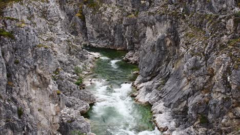 Rapid-mountain-river-flowing-through-deep-canyon