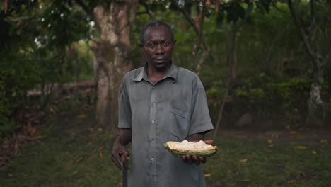 Black-African-local-man-holding-a-cocoa-fruit-in-his-hand-in-a-cinematic-slow-motion