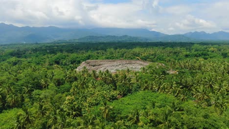 Huge-stack-of-garbage-in-jungle-near-Magelang,-Indonesia,-aerial-view
