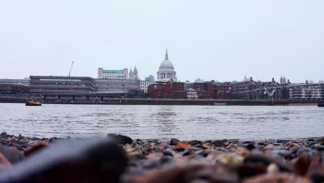 Low-shot-of-snow-falling-from-thames-river-bank-towards-st-pauls-cathedral-London
