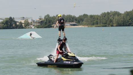 Tracking-shot-of-male-person-with-helmet-flyboarding-and-jumping-underwater