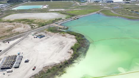 orbiting-aerial-of-a-large-phosphate-pool-in-Piney-Point,-Florida