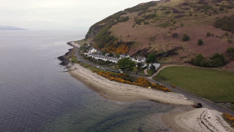 Aerial-view-of-the-Scottish-town-of-Catacol-on-the-Isle-of-Arran-on-an-overcast-day,-Scotland