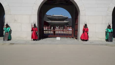 Guardias-Reales-Coreanos-En-Traje-De-Guerrero-Tradicional-Antiguo-De-Pie-Frente-A-La-Puerta-De-Gwanghwamun-Palacio-Gyeongbokgung-Seúl-Corea