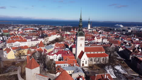 Beautiful-Old-Town-of-Tallinn-Aerial,-Baltic-Sea-Ferries-in-Background