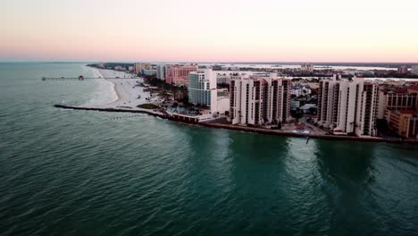 High-Aerial-Push-in-High-Rises-along-Clearwater-Beach-Florida-at-Sunrise