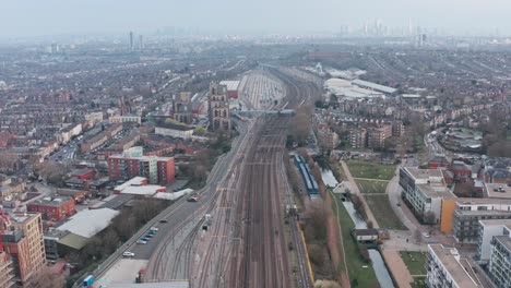 Drone-shot-over-dense-train-tracks-heading-into-London