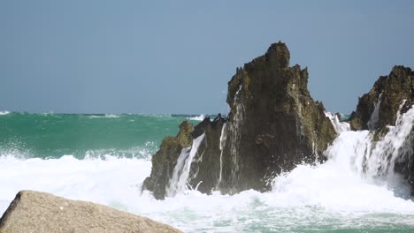 Water-splashes-after-sea-wave-hits-rock-on-coast-of-Hang-Rai,-Vietnam