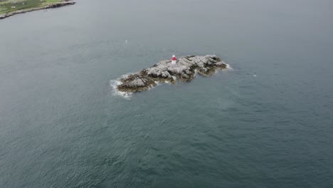 An-aerial-revealing-capture-of-The-Muglins-Lighthouse-during-a-cloudy-day
