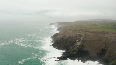 Aerial-rotation-from-the-rocky-shores-of-Cornwall-toward-the-misty-Atlantic-Ocean-horizon