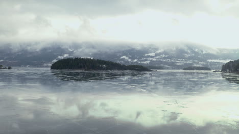 Misty-View-Of-Frozen-Lake-In-Vik-Norway---aerial-shot
