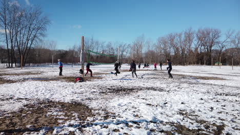 Wide-shot-of-people-playing-winter-beach-volleyball