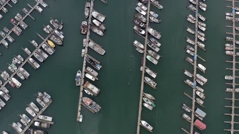 Birds-Eye-Aerial-View-of-Sailing,-Fishing-and-Charter-Boats-and-Yachts-in-Harbor-of-Seward,-Alaska-USA