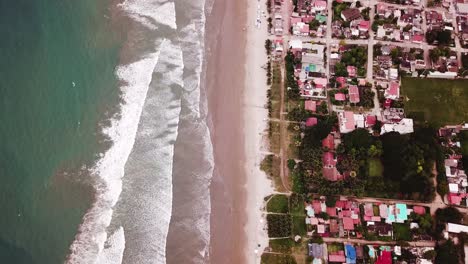 The-Stunning-Scenery-Of-Calm-Waters-Splashing-into-the-shore-in-Olon-Beach---Aerial-Shot