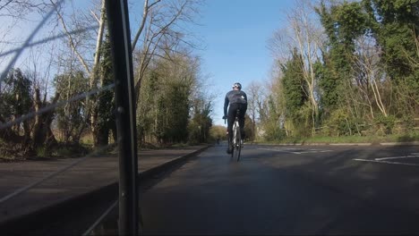 Cyclist-Being-Slowly-Overtaken-By-Other-Riders-On-Countryside-Road