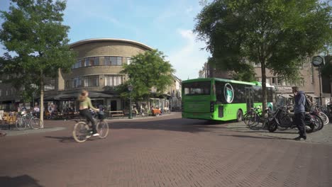 Busy-Netherlands-city-centre,-buses-cyclists-and-pedestrians-in-Leiden-town