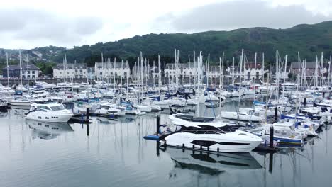 Luxury-yachts-and-sailboats-parked-on-misty-mountain-range-retirement-village-marina-dolly-right-low-angle