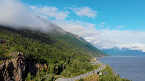 4K-Drone-Video-of-Alaska-Route-1-at-Base-of-Mountain-Along-Shoreline-of-Turnagain-Inlet-Near-Anchorage-During-Summer