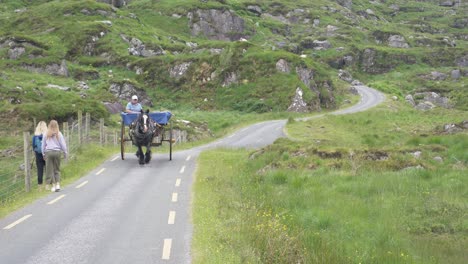 Female-Tourists-And-Horse-Carriage-Traveling-The-Gap-Of-Dunloe-Mountain-Pass-In-County-Kerry,-Ireland