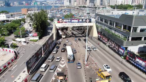 Traffic-heading-in-and-out-of-Hong-Kong-cross-harbor-tunnel,-Aerial-view