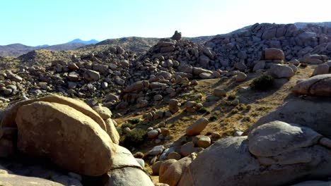 Fly-over-some-big-boulders-in-the-desert-of-southern-California-with-clear-sky-and-no-clouds
