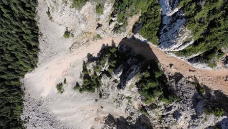 Aerial-View-Of-Sandstone-And-Limestone-Rock-Formation-On-A-Mountain-With-Lush-Green-Trees-On-A-Sunny-Day