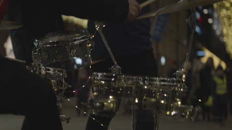 Close-up-of-drummer-plays-drums-in-downtown-at-night