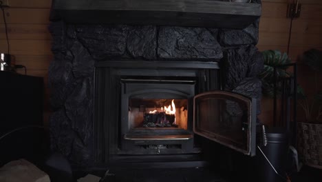 Fire-burning-in-a-beautiful-indoor-black-fireplace