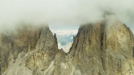 fly-high-through-clouds-at-Langkofel-mountain-peak,-Dolomites-Italy