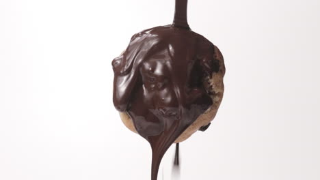 Pouring-Melted-Chocolate-On-Single-Cookie-At-White-Background
