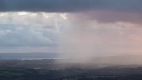 Storm-rain-shower-passing-landscape.-Sunlight-glow-timelapse