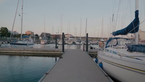 Sail-Boat-at-Ystad-Marina-With-More-Behind,-Wide-Shot-Tracking-Forward